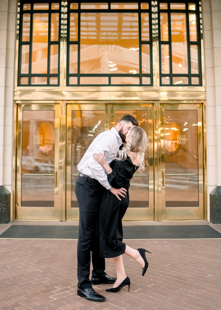 couple kissing in front of bass hall in fort worth