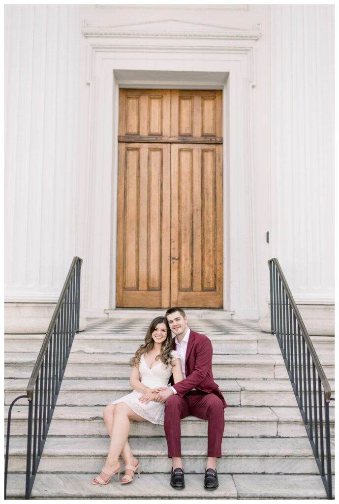couple sitting on the porch of hibernian Hall in charleston south carolina