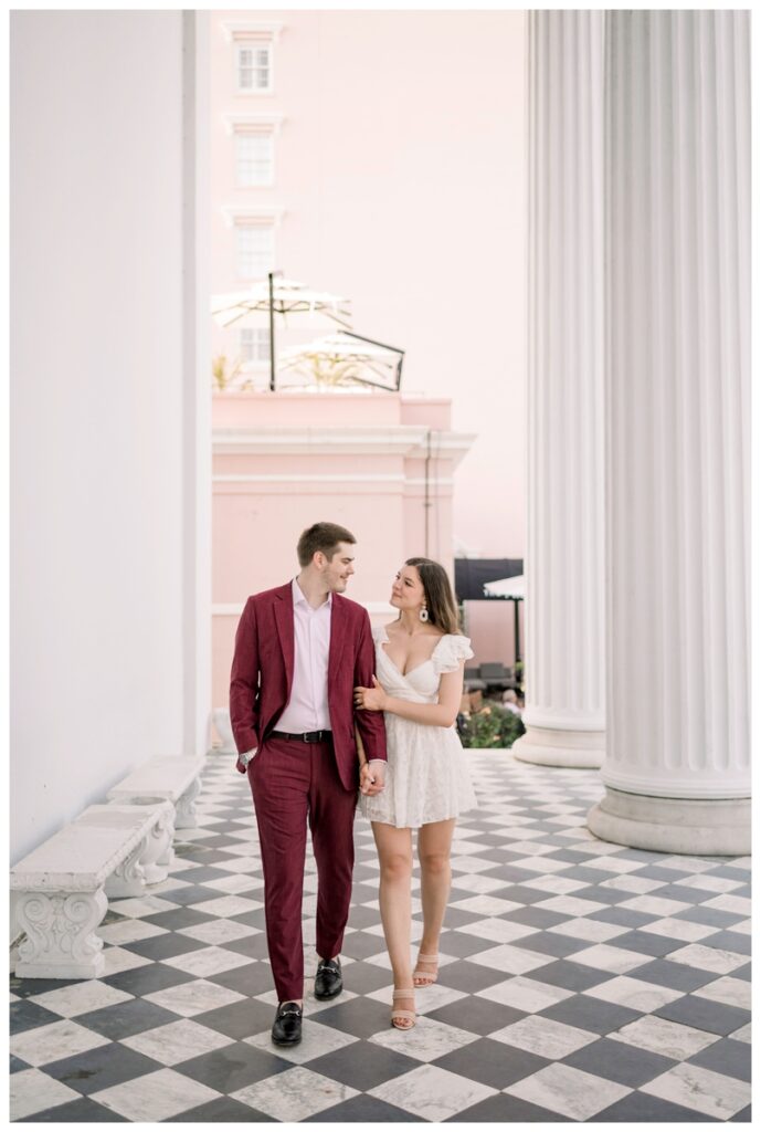couple walking on the porch of hibernian hall in charleston south carolina