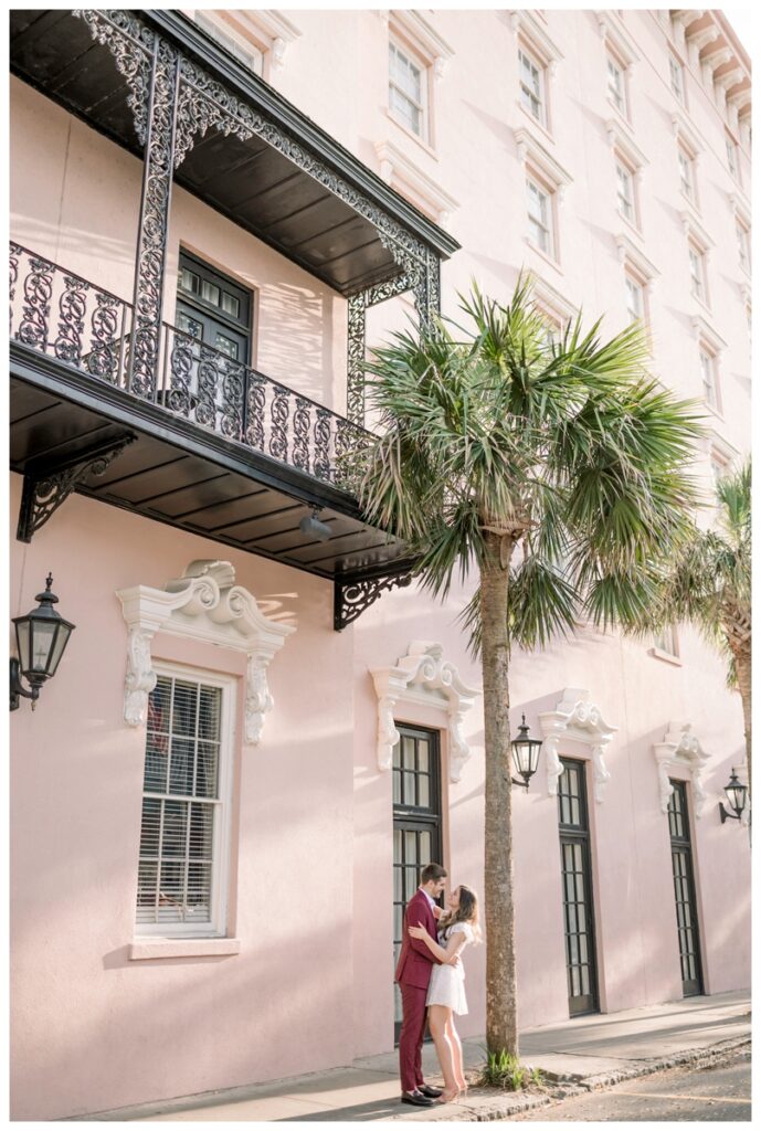 couple standing in front of the mills house hotel in charleston south carolina engagement session