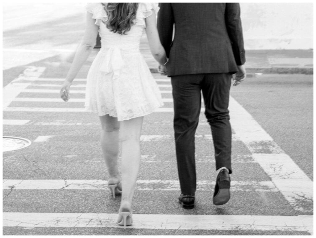 couple walking across the street at 4 corners in charleston south carolina