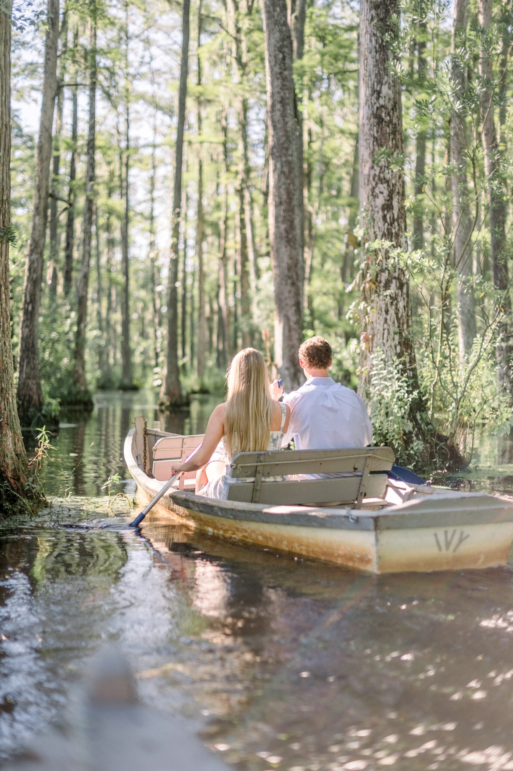 couple in boat at cypress gardens in charleston south carolina notebook inspired engagement shoot