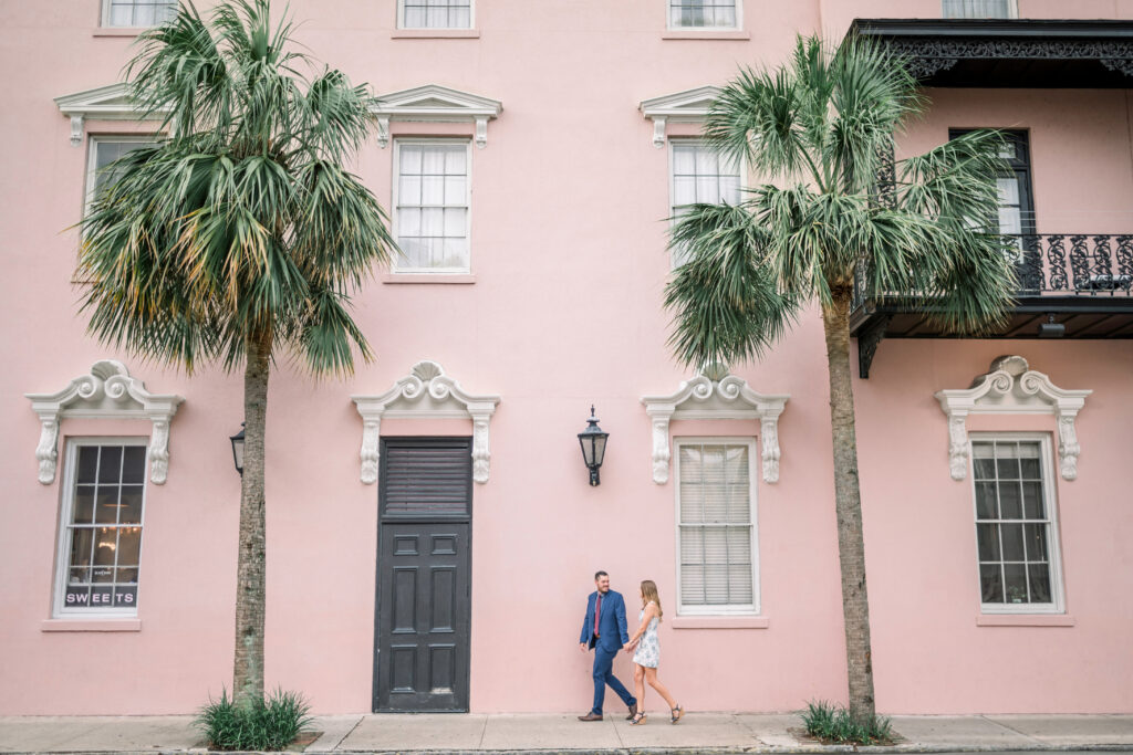 Couple walking down side walk in front of the Mills House Hotel in Charleston, South Carolina