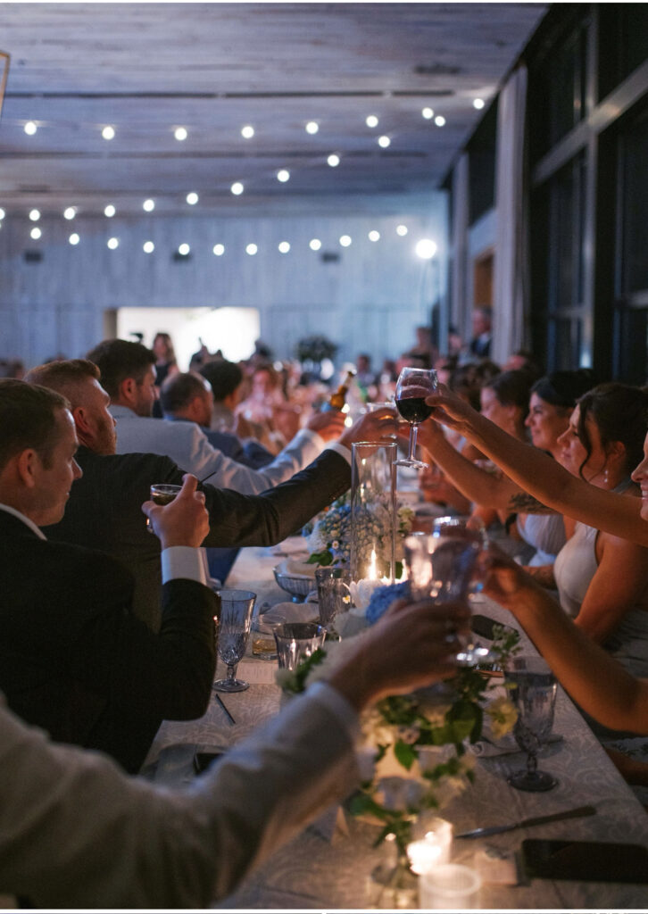 guests clinking glasses across table at middleton